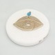 Devil eye brass on marble 7cm.