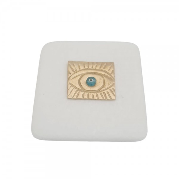 Devil eye brass on marble 7x7cm.